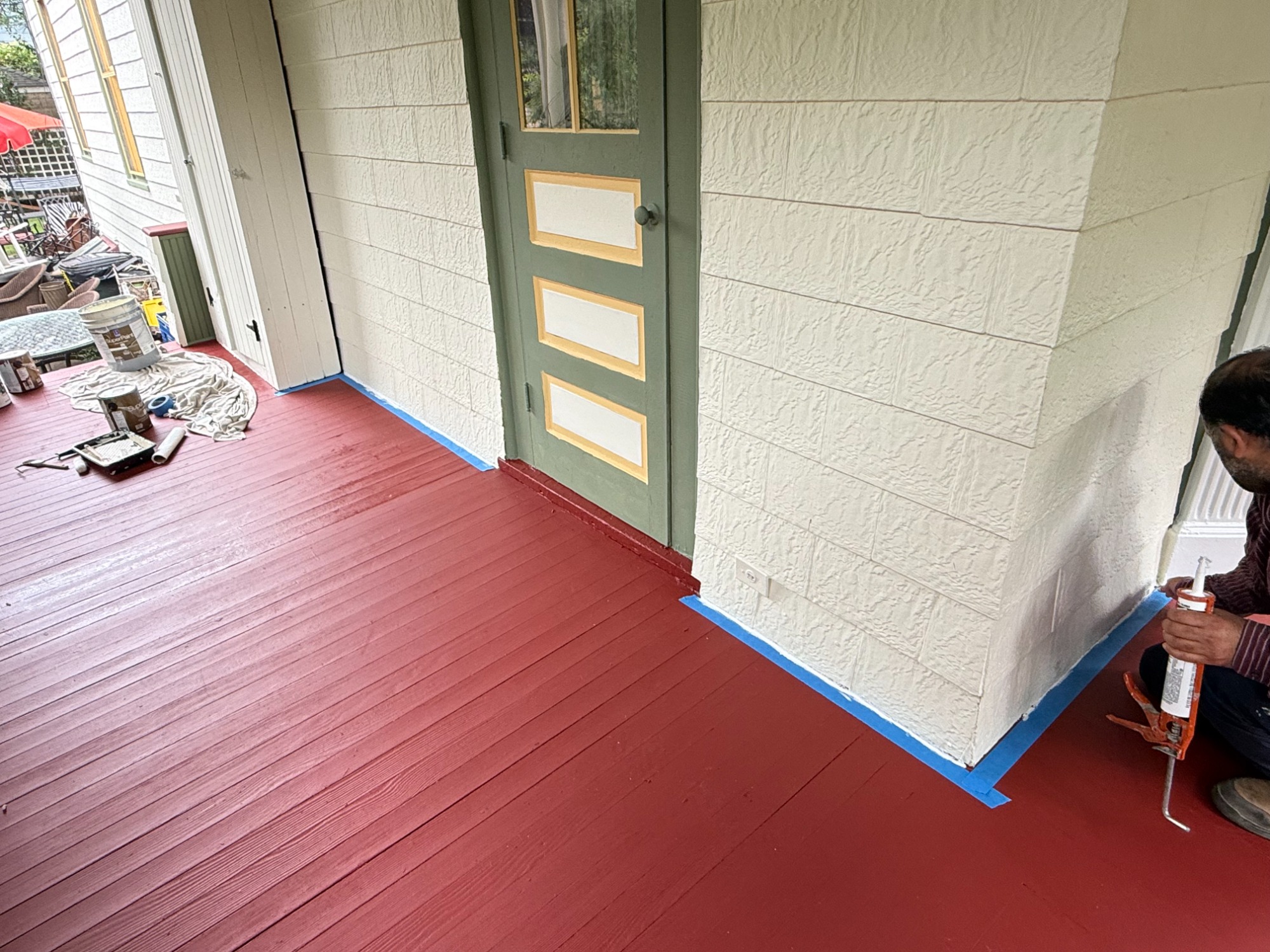 Masked, primed and repainted porch deck and block walls